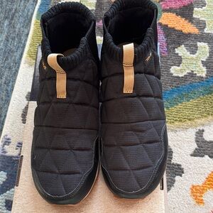 Teva Black Quilted Slip-Ons with Tan Detail